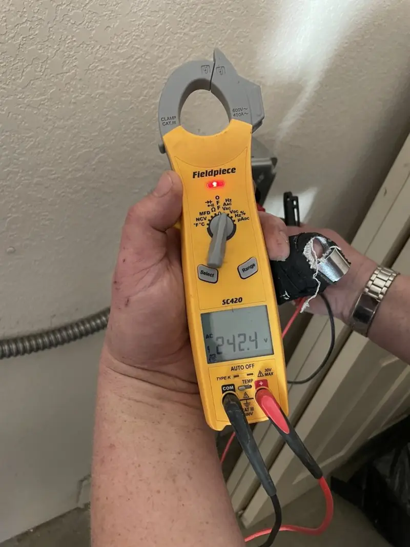 Voltage testing with clamp meter during Whole House Surge Protector in Anthony
